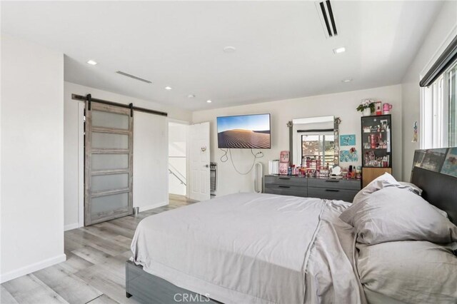 11911 Louise Ave, Granada Hills, CA 91344 - bedroom with a barn door, light wood-style flooring, multiple windows, and recessed lighting