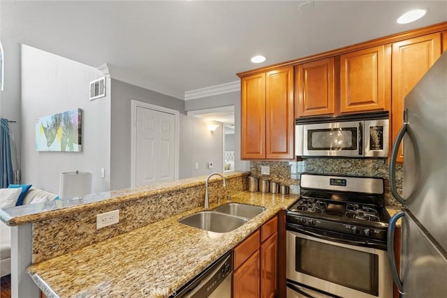4211 Arch Dr Unit 201, Studio City, CA 91604 - kitchen featuring appliances with stainless steel finishes, a peninsula, light stone counters, decorative backsplash, and ornamental molding