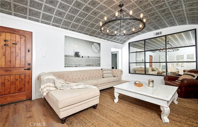 728 Euclid St, Santa Monica, CA 90402 - living room featuring a chandelier, an ornate ceiling, wood finished floors, and vaulted ceiling