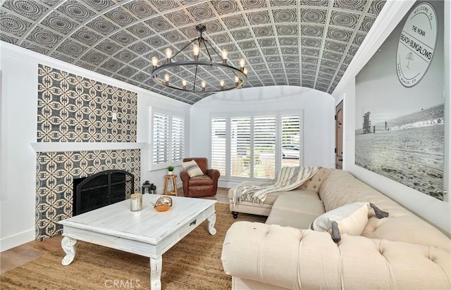 728 Euclid St, Santa Monica, CA 90402 - living area featuring an ornate ceiling, crown molding, a chandelier, a tiled fireplace, and wood finished floors