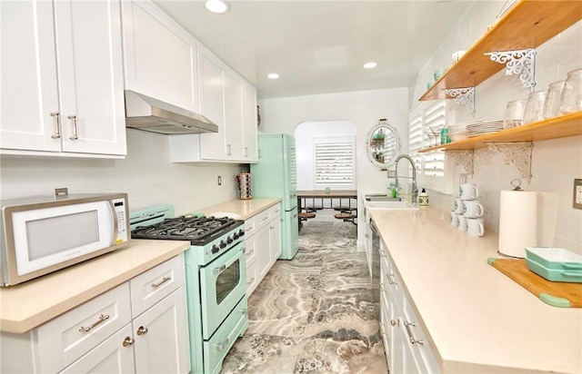 728 Euclid St, Santa Monica, CA 90402 - kitchen featuring white appliances, ventilation hood, open shelves, decorative backsplash, and white cabinets