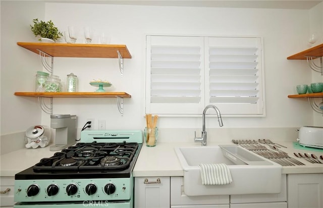 728 Euclid St, Santa Monica, CA 90402 - kitchen with open shelves, range with gas stovetop, and light countertops
