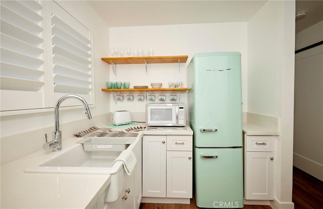 728 Euclid St, Santa Monica, CA 90402 - kitchen featuring white appliances, light countertops, white cabinets, dark wood-style floors, and open shelves