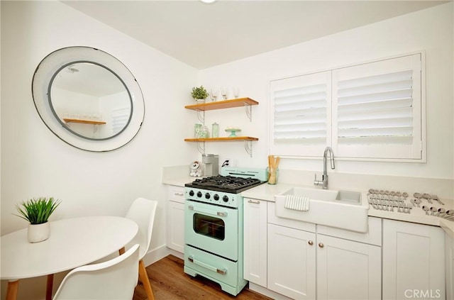 728 Euclid St, Santa Monica, CA 90402 - kitchen featuring gas range oven, light wood-style flooring, light countertops, and white cabinets