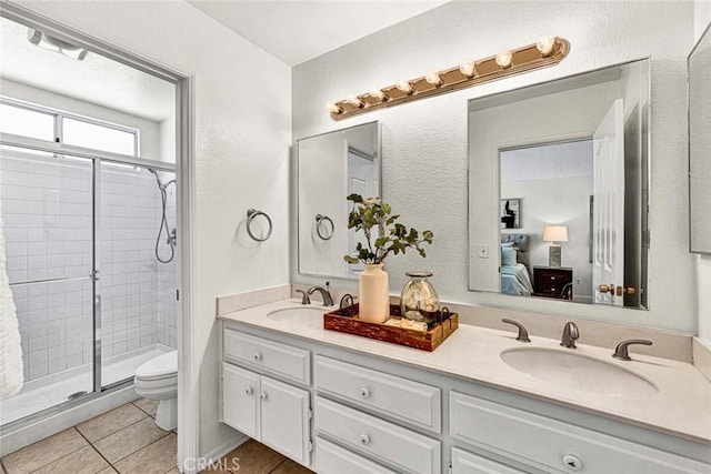 3401 Mountainside Cir, Corona, CA 92882 - ensuite bathroom with double vanity, a stall shower, tile patterned floors, and a textured wall