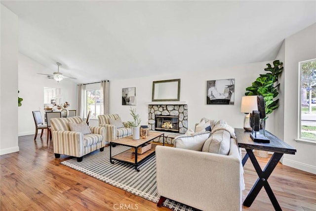 3401 Mountainside Cir, Corona, CA 92882 - living area with light wood-style floors, a fireplace, lofted ceiling, and a ceiling fan
