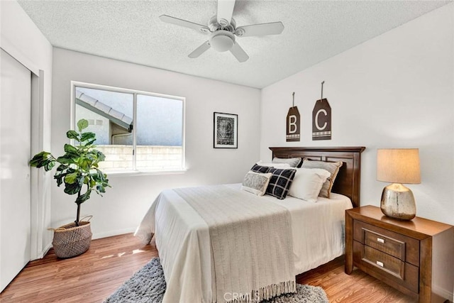 3401 Mountainside Cir, Corona, CA 92882 - bedroom featuring light wood-type flooring, a textured ceiling, and ceiling fan