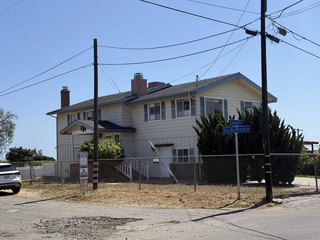 311 Corto, Solana Beach, CA 92075 - view of front of house with a fenced front yard and a chimney