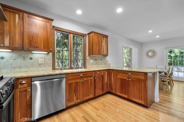 11 Dapplegray Ln, Rolling Hills Estates, CA 90274 - kitchen featuring stainless steel dishwasher, black stove, light wood-style floors, brown cabinetry, and a peninsula