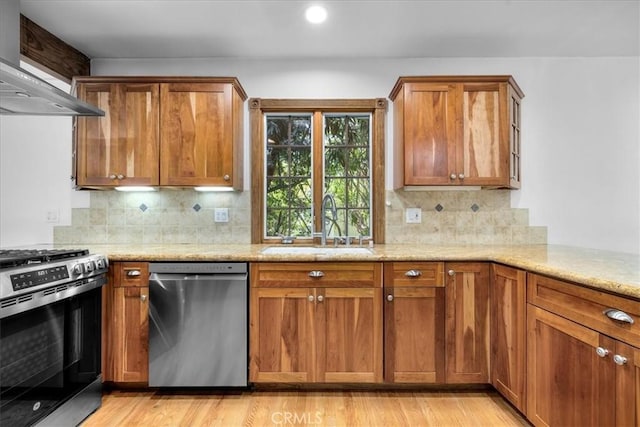 11 Dapplegray Ln, Rolling Hills Estates, CA 90274 - kitchen with stainless steel appliances, wall chimney range hood, light wood finished floors, brown cabinetry, and recessed lighting