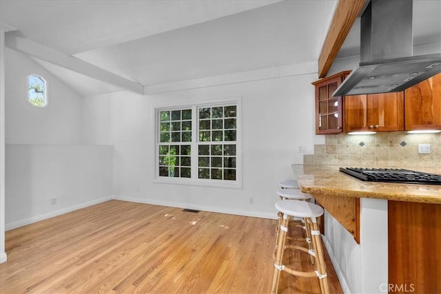 11 Dapplegray Ln, Rolling Hills Estates, CA 90274 - kitchen with wall chimney exhaust hood, gas cooktop, light wood-type flooring, healthy amount of natural light, and lofted ceiling