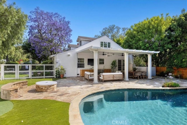 11 Dapplegray Ln, Rolling Hills Estates, CA 90274 - rear view of property with ceiling fan, a fenced backyard, an outdoor living space with a fire pit, a patio area, and stucco siding