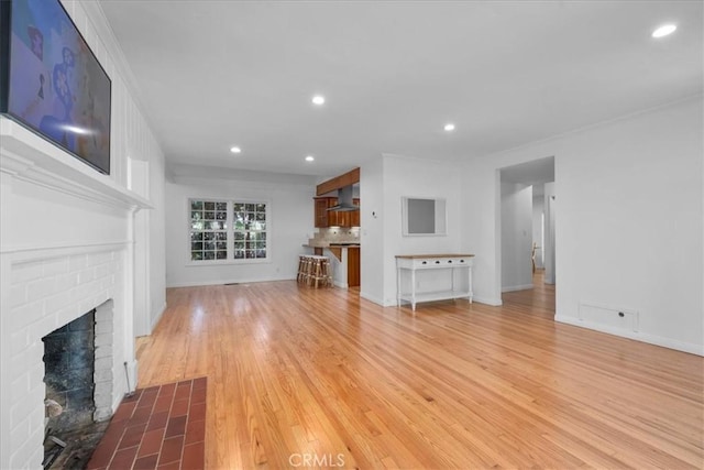 11 Dapplegray Ln, Rolling Hills Estates, CA 90274 - unfurnished living room featuring a brick fireplace, recessed lighting, wood finished floors, and ornamental molding