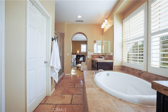1759 Crebs Way, Upland, CA 91784 - bathroom with vanity, a bath, a stall shower, and stone tile flooring