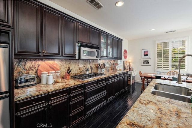 1759 Crebs Way, Upland, CA 91784 - kitchen featuring stainless steel appliances, backsplash, dark wood-type flooring, glass insert cabinets, and light stone countertops
