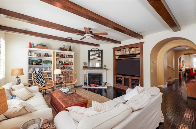 1759 Crebs Way, Upland, CA 91784 - living area with arched walkways, ceiling fan, hardwood / wood-style flooring, beam ceiling, and a fireplace with raised hearth