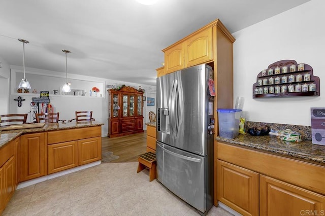 7215 San Pasqual St, Lemon Grove, CA 91945 - kitchen featuring stainless steel refrigerator with ice dispenser, dark stone countertops, and hanging light fixtures