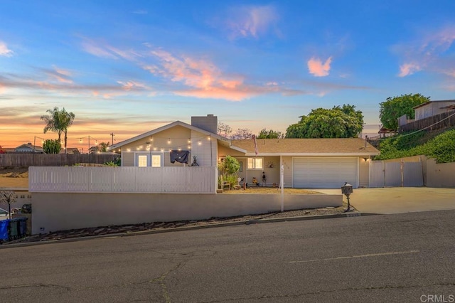 7215 San Pasqual St, Lemon Grove, CA 91945 - mid-century inspired home featuring concrete driveway, a fenced front yard, an attached garage, and a chimney