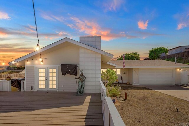 7215 San Pasqual St, Lemon Grove, CA 91945 - view of front of home with french doors, a garage, driveway, and a deck