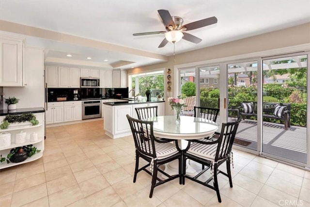 28021 Paseo Reposo, San Juan Capistrano, CA 92675 - dining space with light tile patterned floors, a ceiling fan, a tray ceiling, and recessed lighting