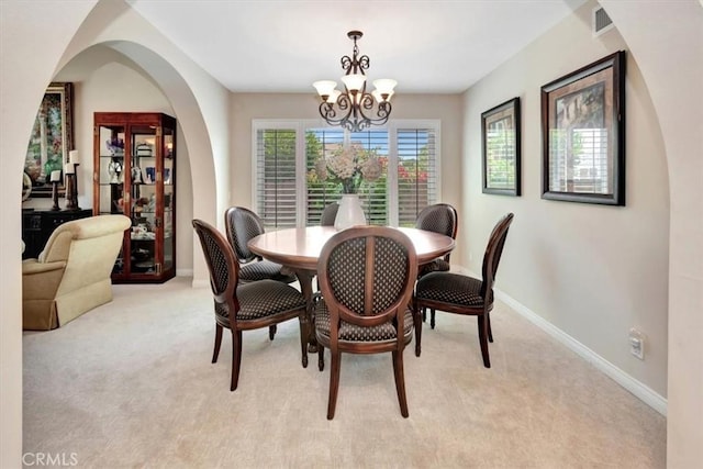 28021 Paseo Reposo, San Juan Capistrano, CA 92675 - dining area featuring light colored carpet, a chandelier, and arched walkways