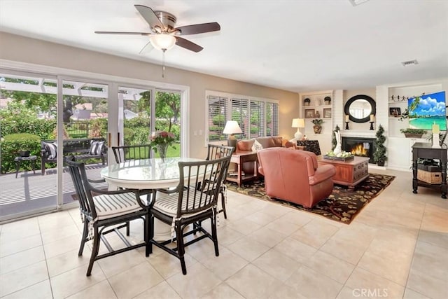 28021 Paseo Reposo, San Juan Capistrano, CA 92675 - dining space featuring built in shelves, a ceiling fan, light tile patterned flooring, and a glass covered fireplace