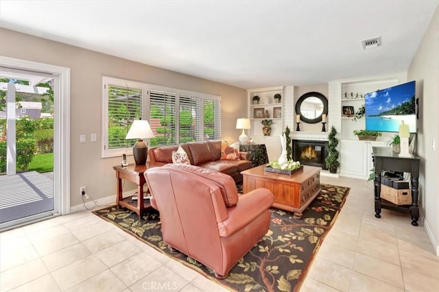 28021 Paseo Reposo, San Juan Capistrano, CA 92675 - living area with light tile patterned floors, a glass covered fireplace, and built in features