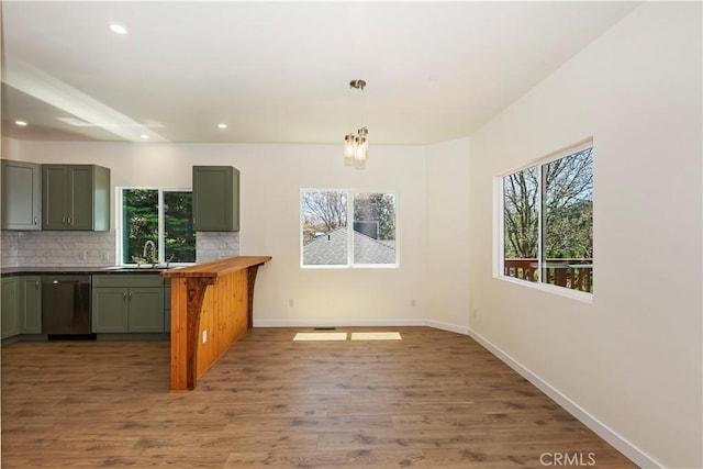 26182 Sky Ridge Dr, Twin Peaks, CA 92391 - kitchen featuring dishwasher, decorative backsplash, recessed lighting, wood finished floors, and hanging light fixtures