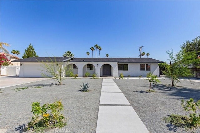 2852 E San Angelo Rd, Palm Springs, CA 92262 - single story home featuring an attached garage, concrete driveway, stucco siding, and a porch