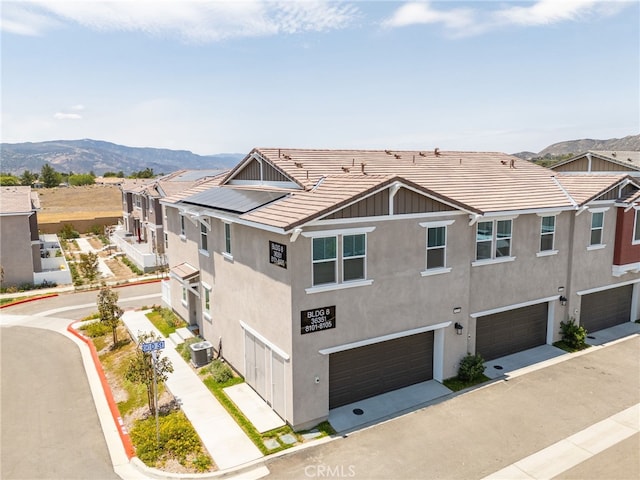 36351 Elizabeth Ln Unit 8105, Wildomar, CA 92595 - view of side of home with a garage, stucco siding, a tiled roof, and a mountain view