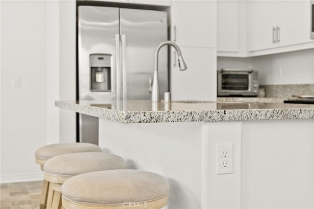 36351 Elizabeth Ln Unit 8105, Wildomar, CA 92595 - kitchen featuring white cabinets, stainless steel refrigerator with ice dispenser, and light stone countertops