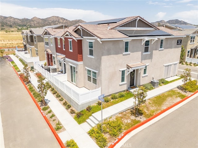 36351 Elizabeth Ln Unit 8105, Wildomar, CA 92595 - view of front of home featuring a mountain view, stucco siding, solar panels, and a residential view