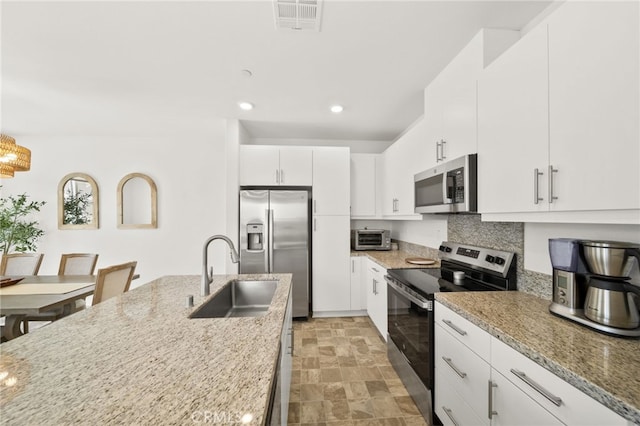 36351 Elizabeth Ln Unit 8105, Wildomar, CA 92595 - kitchen with stainless steel appliances, recessed lighting, light stone countertops, white cabinets, and backsplash