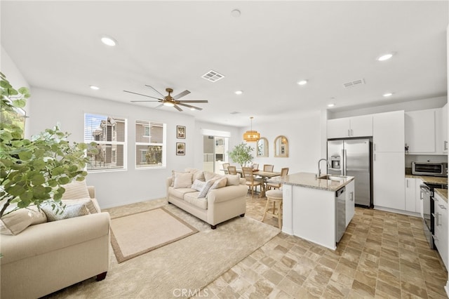36351 Elizabeth Ln Unit 8105, Wildomar, CA 92595 - living area with recessed lighting, ceiling fan, and light stone finish floors