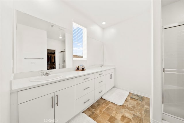36351 Elizabeth Ln Unit 8105, Wildomar, CA 92595 - bathroom with double vanity, a shower stall, stone finish flooring, and a spacious closet