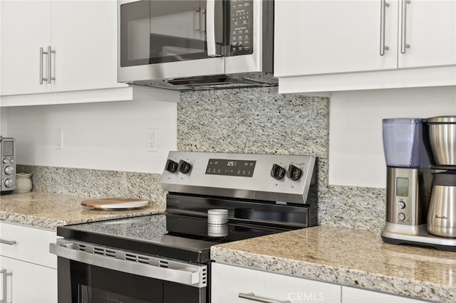 36351 Elizabeth Ln Unit 8105, Wildomar, CA 92595 - kitchen featuring appliances with stainless steel finishes, white cabinetry, decorative backsplash, and light stone countertops