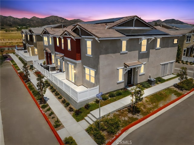 36351 Elizabeth Ln Unit 8105, Wildomar, CA 92595 - view of front of property with stucco siding, solar panels, a mountain view, and a tile roof
