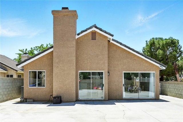 2027 Cape Cod Ln, Palmdale, CA 93550 - back of property featuring a patio area, a chimney, and stucco siding