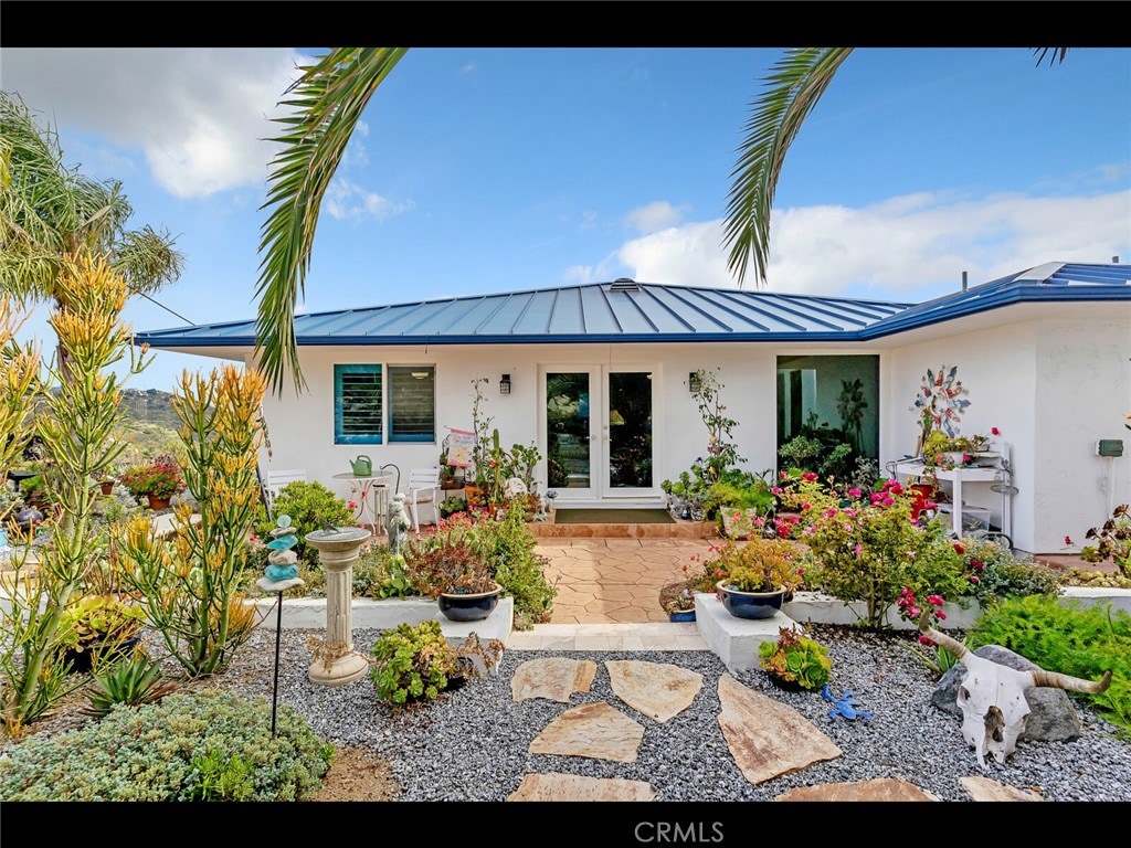 31460 Aquaduct Rd, Bonsall, CA 92003 - rear view of property featuring stucco siding, a standing seam roof, and a metal roof
