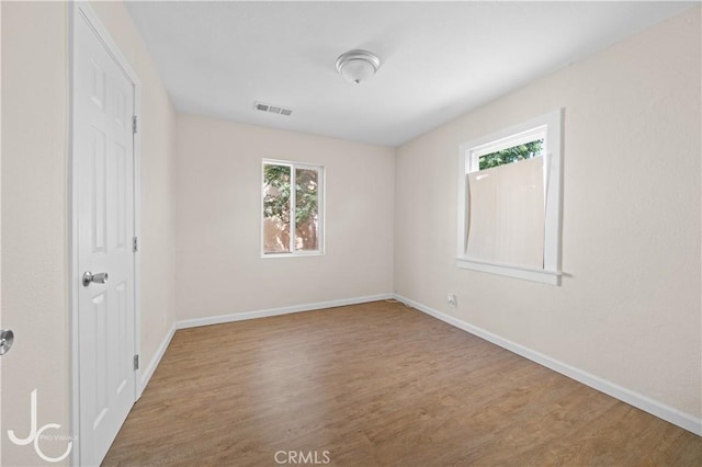 531 7th, Bakersfield, CA 93304 - unfurnished bedroom featuring multiple windows and wood finished floors