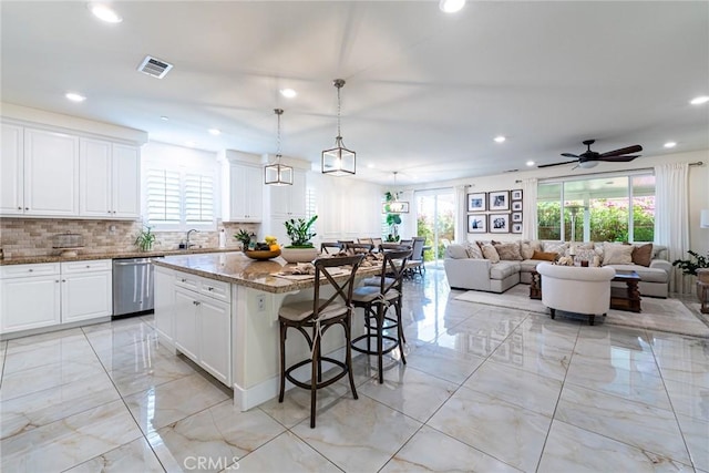 13211 Baxter Springs Dr, Rancho Cucamonga, CA 91739 - kitchen featuring stainless steel dishwasher, plenty of natural light, light marble finish floors, and recessed lighting