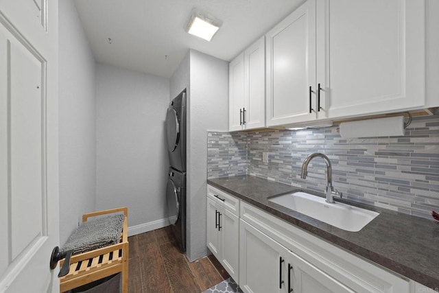 3676 Valley Rd, Bonita, CA 91902 - laundry room with stacked washer / dryer, dark wood-style flooring, and cabinet space