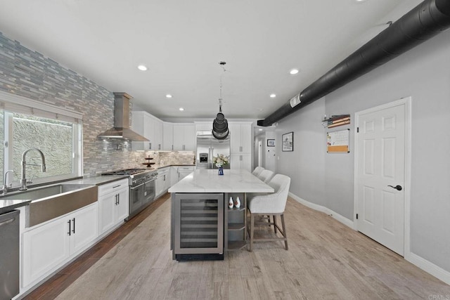 3676 Valley Rd, Bonita, CA 91902 - kitchen featuring wine cooler, wall chimney exhaust hood, stainless steel appliances, decorative backsplash, and a kitchen bar
