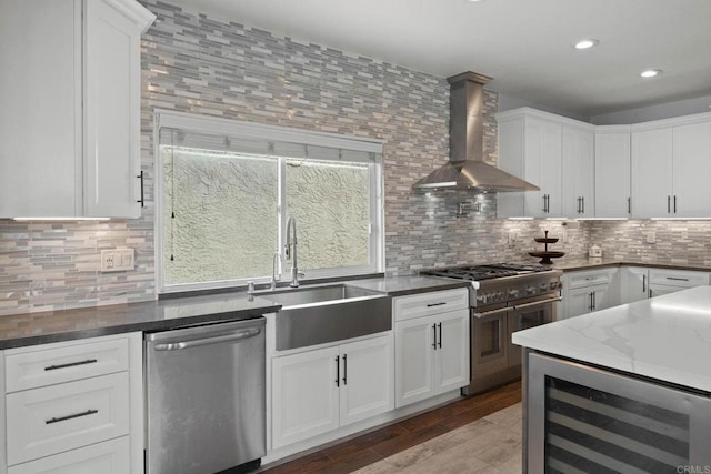 3676 Valley Rd, Bonita, CA 91902 - kitchen featuring appliances with stainless steel finishes, wall chimney exhaust hood, beverage cooler, white cabinets, and backsplash