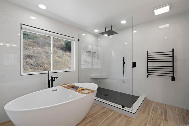 3676 Valley Rd, Bonita, CA 91902 - full bathroom with tiled shower, a soaking tub, a towel warming rack, radiator heating unit, and tile walls