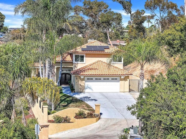 3676 Valley Rd, Bonita, CA 91902 - mediterranean / spanish home featuring a gate, stucco siding, driveway, an attached garage, and a tiled roof