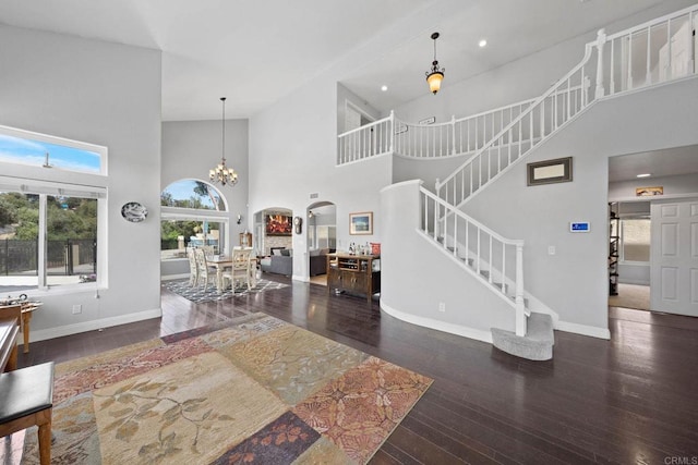 3676 Valley Rd, Bonita, CA 91902 - living area featuring a high ceiling, stairs, wood-type flooring, arched walkways, and recessed lighting