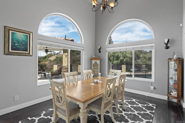 3676 Valley Rd, Bonita, CA 91902 - dining area featuring healthy amount of natural light, a chandelier, wood finished floors, and a towering ceiling