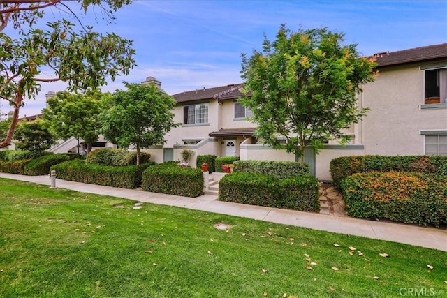 11 Exeter, Irvine, CA 92612 - view of property featuring stucco siding, a front lawn, and a chimney