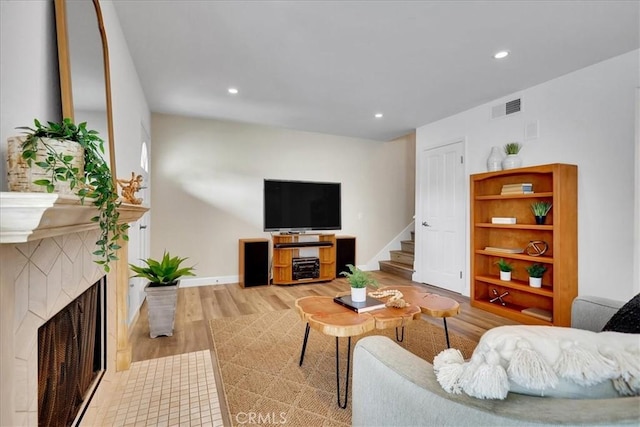 11 Exeter, Irvine, CA 92612 - living area featuring wood finished floors, stairway, recessed lighting, and a fireplace